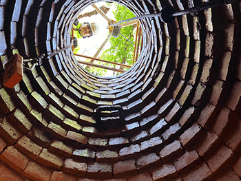 worker looking down a manhole