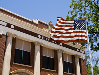 American flag in front of a city hall