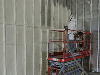 ECM worker in a lift weatherizing building.