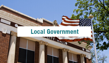 American flag in front of a city hall building