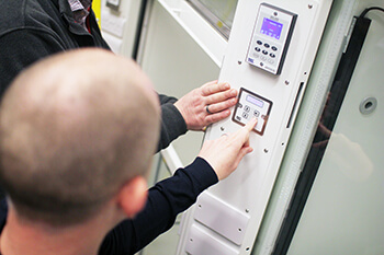 Workers pointing at air flow controller