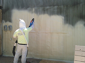 Worker applying spray foam