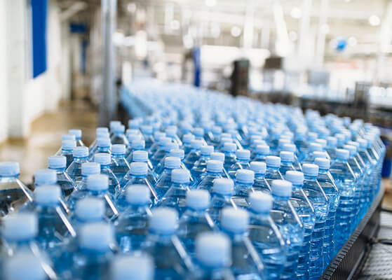 A bunch of water bottles on a processing plant line